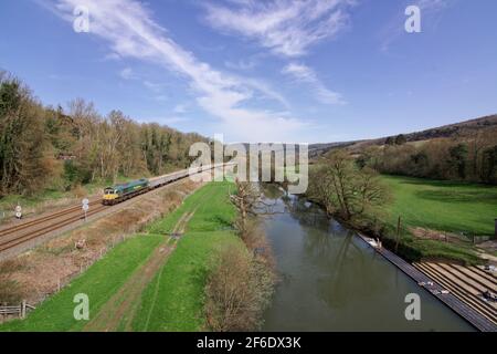 Le jour de mars le plus chaud depuis 1968, la Locomotive diesel de classe 66 66621 de la Livery Freightliner passe les baigneurs de soleil et les nageurs avec le 604T Banque D'Images