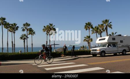 Oceanside, Californie États-Unis - 8 février 2020 : camping-car et personnes marchant, surfeurs et planches de surf sur la route du front de mer. Océan Pacifique tropical plage touristique r Banque D'Images