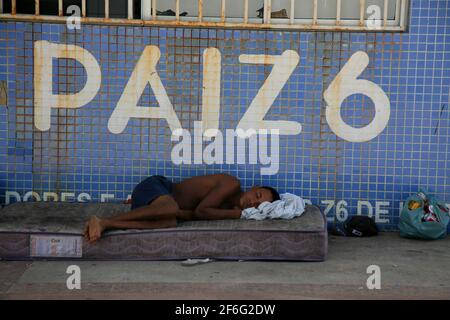 salvador, bahia, brésil - 21 décembre 2020 : un homme sans abri est vu dormir à côté de la colonie de pêche Z6 sur la plage d'Itapua, dans la ville de Salvador. *** Banque D'Images