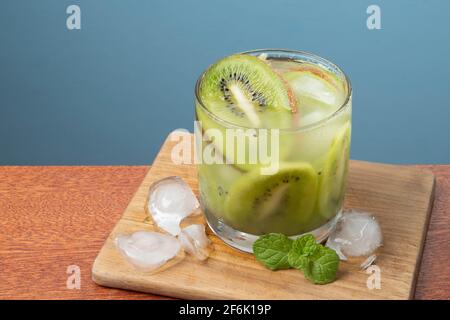 boisson alcoolisée caipirinha à base de kiwi et aguardente cocktail distillé buvez et des fruits sur fond bleu Banque D'Images