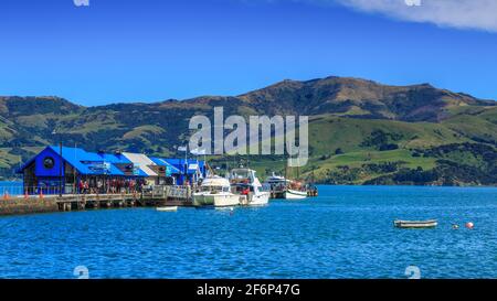 Le quai principal d'Akaroa, en Nouvelle-Zélande, avec des bateaux de visite reliés Banque D'Images