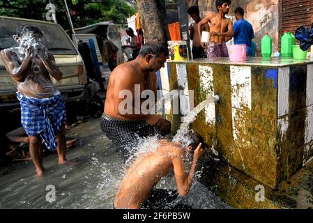 Kolkata, Inde. 02 avril 2021. Les gens ont vu prendre un bain d'un tube d'eau en bord de route bien un matin chaud d'été à Kolkata . Crédit : SOPA Images Limited/Alamy Live News Banque D'Images