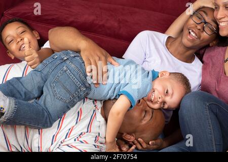 Portrait de famille heureux des enfants et des parents se blotti ensemble Banque D'Images