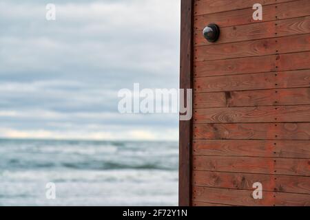 Caméra IP CCTV avec système de sécurité installé sur un mur en bois sur fond de paysage marin. Zone protégée, station de garde côtière. Banque D'Images