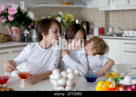 Enfants, frères et sœurs, œufs de coloriage pour Pâques à la maison Banque D'Images