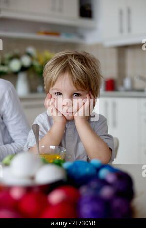 Enfants, frères et sœurs, œufs de coloriage pour Pâques à la maison Banque D'Images