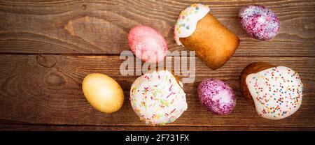 Gâteaux de Pâques et œufs de couleur Pâques sur fond de bois. Fête religieuse de Pâques. Banque D'Images