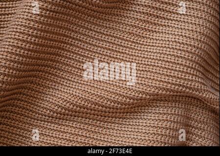 Texture d'un pull brun en laine. Arrière-plan du tissu. Banque D'Images