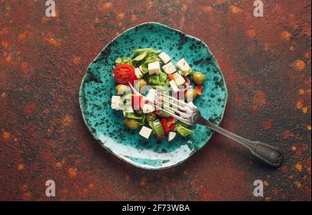 Assiette avec salade grecque fraîche sur fond de gringe Banque D'Images