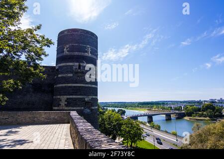 Angers, France - 23 août 2019 : les murs extérieurs de l'ancien château médiéval Angers et du fleuve Maine dans la ville d'Angers dans le département Maine-et-Loire Banque D'Images