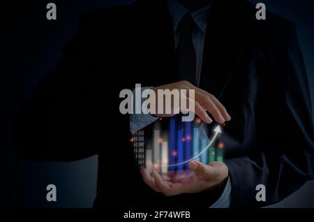 Homme d'affaires analyse le graphique de croissance et en appuyant sur le bouton graphique sur les écrans virtuels, Business concept Data digital. Banque D'Images