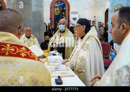 Mossoul, Ninive, Irak. 3 avril 2021. Le Priest irakien prêche pendant la messe de Pâques à l'église Grand Immaculée (al-Tahira-l-Kubra) dans la ville de Qaraqosh (Al-Hamdaniya), à 30 kilomètres au sud-est de la ville de Mossoul.Easter est considéré comme la plus grande et la plus grande fête chrétienne, Comme il commémore la résurrection du Christ des morts après trois jours de sa crucifixion et de sa mort, tel qu'écrit dans le Nouveau Testament, dans lequel le Grand Carême qui dure habituellement quarante jours se termine. Pendant la liturgie, les hymnes sont chantés, des parties de l'ancien Testament de la Bible sont récitées, les hymnes du Halleluj Banque D'Images