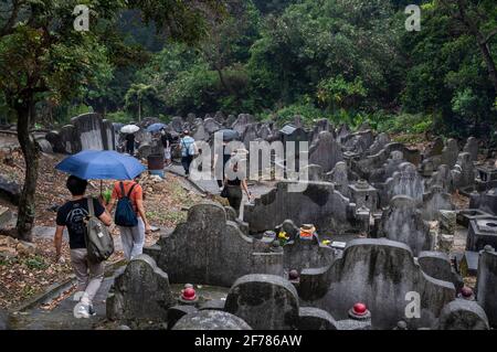 Hong Kong, Chine. 04e avril 2021. Les gens marchent à travers les pierres tombales dans un cimetière pendant le Ching Ming Festival à Hong Kong. Le Ching Ming Festival annuel, Lorsque les gens visitent les tombes de parents décédés et quittent leur famille en souvenir et dans le respect que le gouvernement de Hong Kong tente de garder le nombre de cas infectés par le coronavirus COVID-19 sous contrôle alors que davantage de personnes se font vacciner. (Photo par Miguel Candela/SOPA Images/Sipa USA) crédit: SIPA USA/Alay Live News Banque D'Images