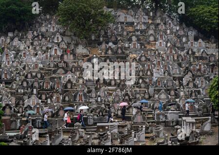 Hong Kong, Chine. 04e avril 2021. Les gens marchent à travers les pierres tombales dans un cimetière pendant le Ching Ming Festival à Hong Kong. Le Ching Ming Festival annuel, Lorsque les gens visitent les tombes de parents décédés et quittent leur famille en souvenir et dans le respect que le gouvernement de Hong Kong tente de garder le nombre de cas infectés par le coronavirus COVID-19 sous contrôle alors que davantage de personnes se font vacciner. (Photo par Miguel Candela/SOPA Images/Sipa USA) crédit: SIPA USA/Alay Live News Banque D'Images