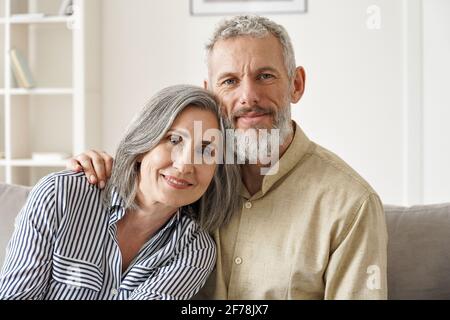 Couple d'âge moyen mûr et heureux, enserrer à la maison. Gros plan portrait. Banque D'Images