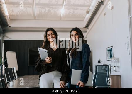 Femmes d'affaires souriantes dans la salle de réunion Banque D'Images