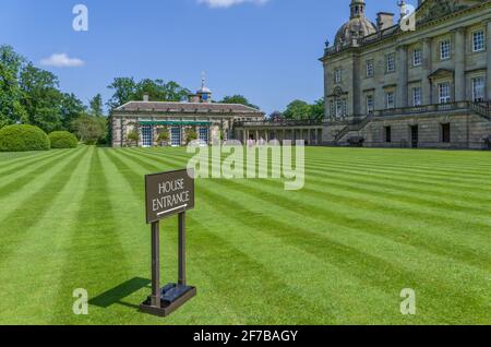 Houghton Hall Gardens, Norfolk, Royaume-Uni; panneau d'entrée de la maison, pelouse rayée et le hall au loin Banque D'Images