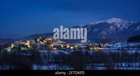 La montagne de Tosa d'Alp et le village de Bellver de Cerdanya au crépuscule enneigé de l'hiver - heure bleue (Catalogne, Espagne, Pyrénées) Banque D'Images