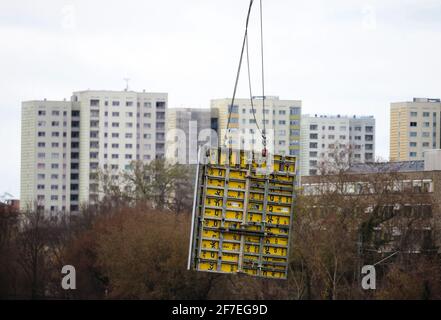 Potsdam, Allemagne. 06e avril 2021. Une grue transporte le coffrage jusqu'à la fosse d'excavation du chantier de construction du quartier de Havel. Les gratte-ciel de Zeppelinstrasse sont visibles en arrière-plan. Le nouveau quartier avec des espaces commerciaux, des appartements et un hôtel dans la Speicherstadt devrait être achevé d'ici 2025. Credit: Soeren Stache/dpa-Zentralbild/dpa/Alay Live News Banque D'Images