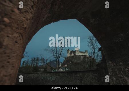 Forteresse historique Hohensalzburg ou festung dans la soirée coucher du soleil vue à travers l'ancien portail à une heure bleue le soir froid novembre soir. Colo bleu riche Banque D'Images