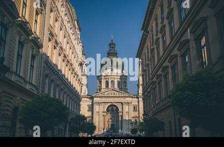 La célèbre cathédrale catholique romaine de Szent Istvan à Budapest, vue de la rue commerçante en face de celle-ci, un jour d'automne ensoleillé. Banque D'Images