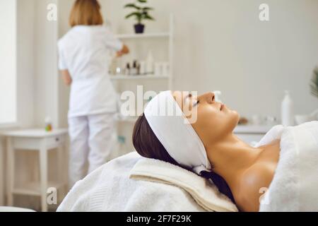 Les jeunes femmes se détendent du visage après un soin de la peau ou un massage dans le salon de beauté et de bien-être Banque D'Images