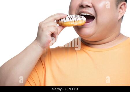 Young man eating donut Banque D'Images