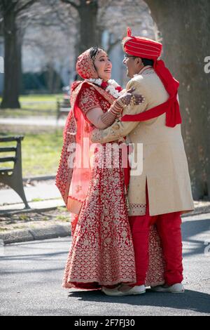 Un couple hindou en vêtements ethniques ornés pose pour des photos dans un parc à Queens, New York. Banque D'Images