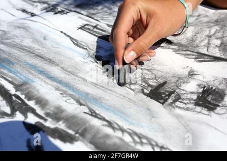 Gros plan de la main femelle dessin à l'extérieur à la plage à St Ives ,Cornwall ,Angleterre.Femme artiste dessin au charbon de bois . Banque D'Images