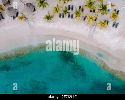 Resort de luxe tropical Curaçao avec plage privée et palmiers, vacances de luxe Curaçao Caraïbes, vue sur la plage tropicale drone avec parasol et chaises sur la plage et palmiers Banque D'Images