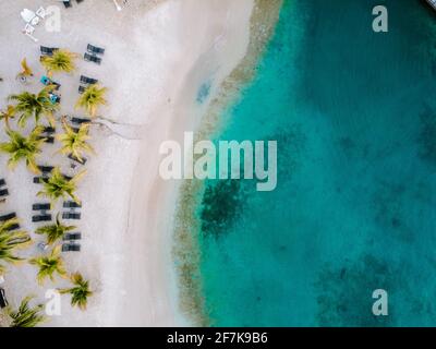 Resort de luxe tropical Curaçao avec plage privée et palmiers, vacances de luxe Curaçao Caraïbes, vue sur la plage tropicale drone avec parasol et chaises sur la plage et palmiers Banque D'Images