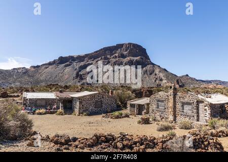 Un groupe de marcheurs déjeunant dans les vestiges des anciens bâtiments du sanatorium, en raison de travaux de démolition, dans le parc national Las Canadas del Teide, Tener Banque D'Images