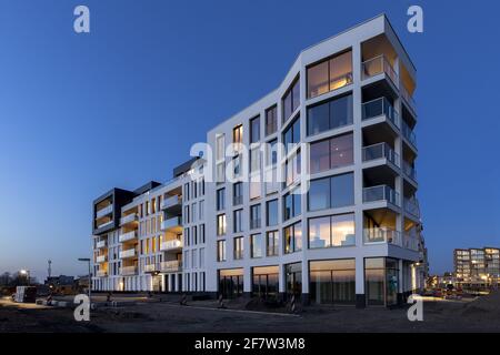 ZUTPHEN, PAYS-BAS - 30 mars 2021 : vue graphique d'un complexe contemporain d'architecture d'appartements de luxe avec façade blanche éclairée par ou Banque D'Images