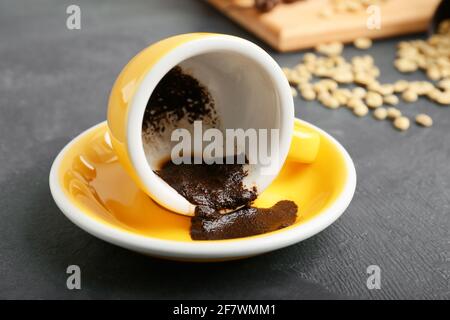 Tasse avec café moulu dépensé pour raconter de la fortune sur la table Banque D'Images