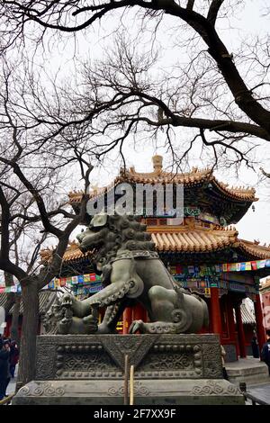 Des statues en pierre de lion, entourées de branches d'arbres, se trouvent devant le pavillon. Banque D'Images