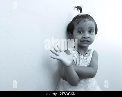 Gros plan d'une fille indienne isolée sur fond blanc en monochrome, Kalaburagi, Karnataka, Inde-avril 02.2021 Banque D'Images