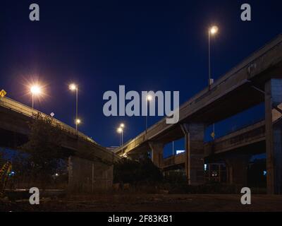 Nuit dans une ville avec un grand pont en béton entremêlé été Banque D'Images