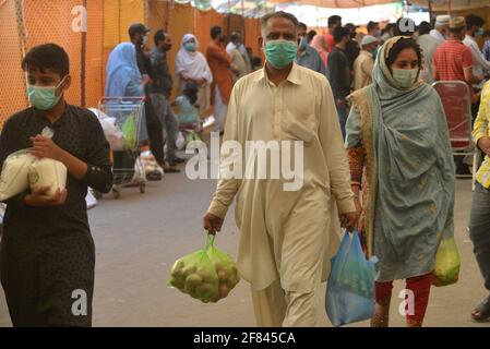 Lahore, Pakistan. 11 avril 2021. Les Pakistanais achètent de la farine, des sachets de sucre, des fruits et des légumes à des taux de contrôle auprès de Ramzan Sasta Bazar, dans la ville de Shalamar, dans le cadre du programme de secours du Ramadan organisé par le gouvernement provincial avant le mois Saint des musulmans de Ramzan-ul-mubarak à Lahore. (Photo de Rana Sajid Hussain/Pacific Press) Credit: Pacific Press Media production Corp./Alay Live News Banque D'Images