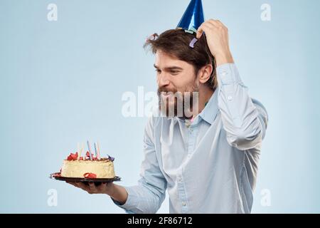Homme Avec Une Assiette De Gateau Et Une Bougie De Fete Chapeau Bleu Pour La Fete D Entreprise Photo Stock Alamy