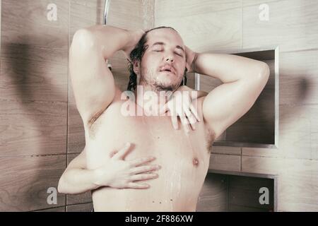 Drôle de gras homme chante dans la douche. Banque D'Images