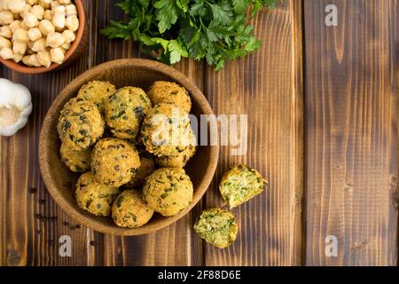 Falafel de pois chiches dans le bol brun sur fond de bois.vue du dessus.espace de copie. Banque D'Images