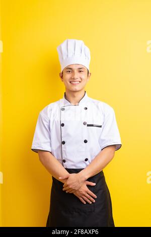 Image d'un chef asiatique sur fond jaune Banque D'Images