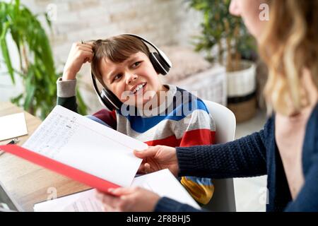 Gros plan de maman vérifiant les devoirs de maths de son fils Banque D'Images