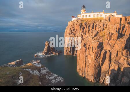 Spectaculaire coucher de soleil doré ou lever de soleil sur la péninsule côtière de Neist point Lighthouse, sur l'île de Skye, en Écosse. Banque D'Images