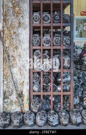 Pièces de rechange pour engrenages et moteurs dans un atelier de réparation automobile, sombres et sales Banque D'Images