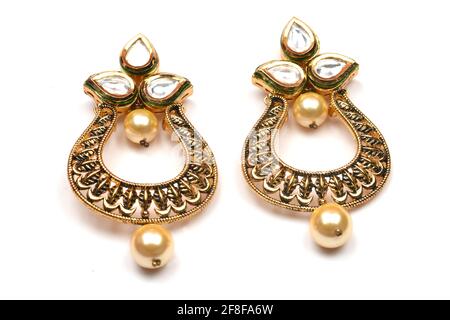 Belle paire dorée de boucles d'oreilles diamants pierres précieuses sur fond blanc bijoux traditionnels indiens, boucles d'oreilles de mariée or bijoux de mariage Banque D'Images