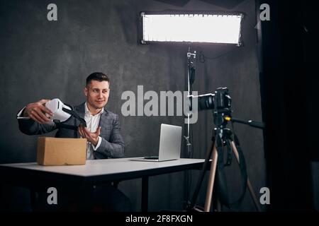 Beau jeune homme enregistrant la vidéo de unboxing pour le blog Banque D'Images