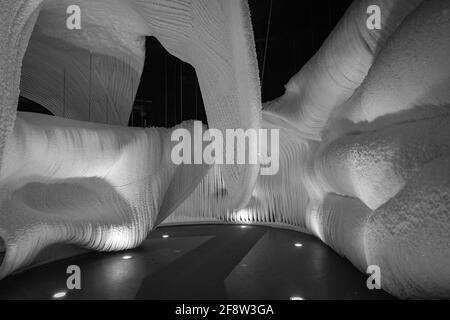 Une fabuleuse grotte de glace artificielle, les murs sont couverts de neige et illuminés. Glace congelée et froide à l'intérieur Banque D'Images