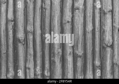 Panneaux de clôture peints en gris foncé texture bois noir sur fond de bois. Banque D'Images