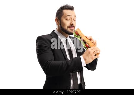 Homme d'affaires mangeant un sandwich dans une baguette et appréciant isolé sur fond blanc Banque D'Images